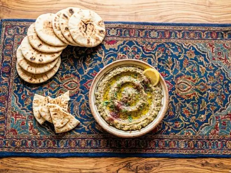 Smoky baba ganoush dip with olive oil drizzle and pita.