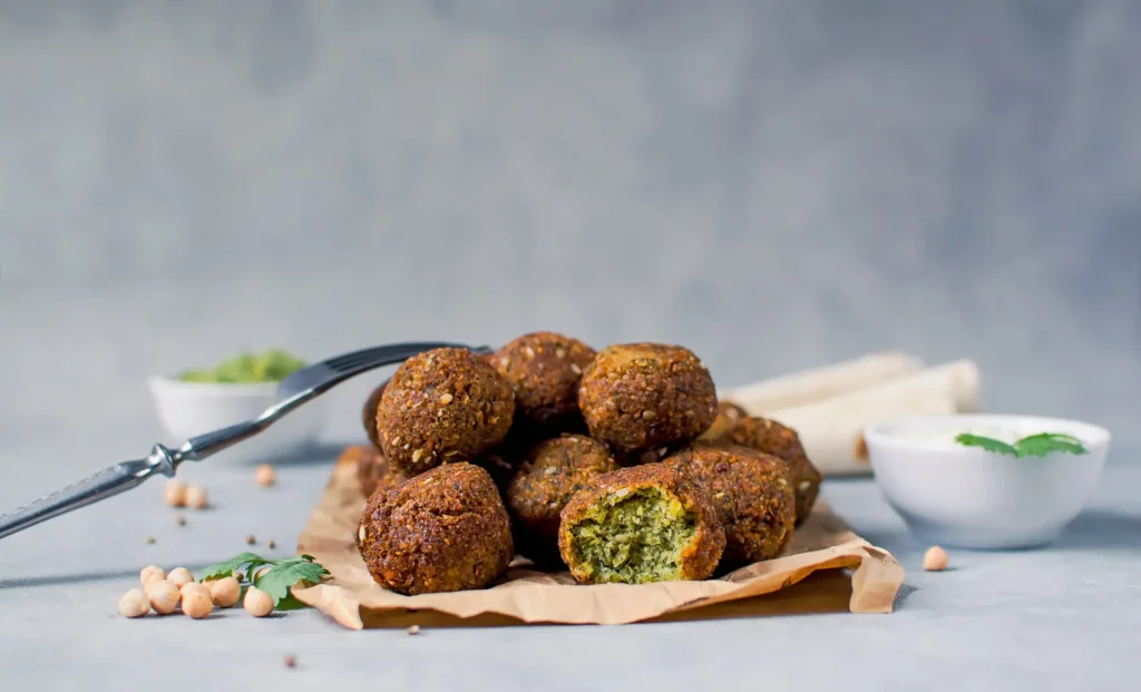 Crispy golden halal falafel with tahini sauce and chickpeas at Aladdin Mediterranean Cuisine Houston