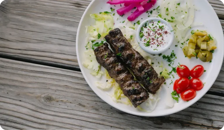 Halal kafta kabob with minced beef and lamb, pickled turnips, and tzatziki at Aladdin Mediterranean Cuisine Houston