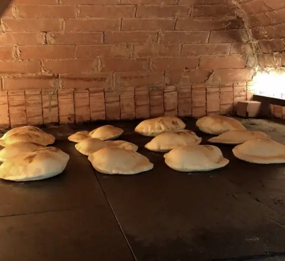 a group of bread in a brick oven