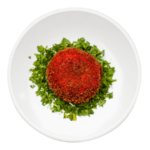 Baked Mashed Potato surrounded in chopped parsley on a round white plate