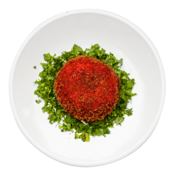 Baked Mashed Potato surrounded in chopped parsley on a round white plate