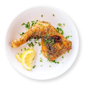 Baked chicken leg quarter from Aladdin Mediterranean Cuisine—crispy golden skin, juicy meat.