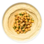 Classic Hummus dip with chickpeas in the center in a white bowl
