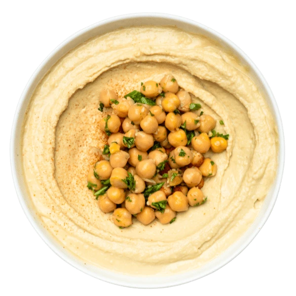 Classic Hummus dip with chickpeas in the center in a white bowl