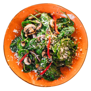 Spinach Feta Salad with bell pepper and mushroom in a sound orange plate
