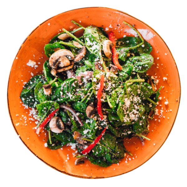 Spinach Feta Salad with bell pepper and mushroom in a sound orange plate
