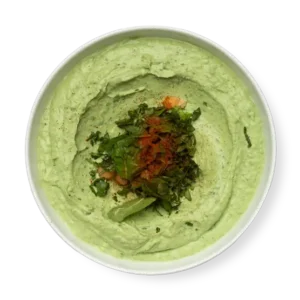 Spinach Hummus a green dip on a white plate