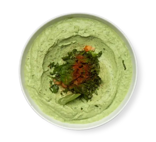 Spinach Hummus a green dip on a white plate