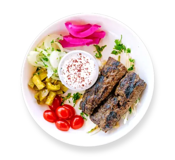 Kafta kabob skewers served over rice with grilled vegetables at Aladdin Mediterranean Cuisine in Houston