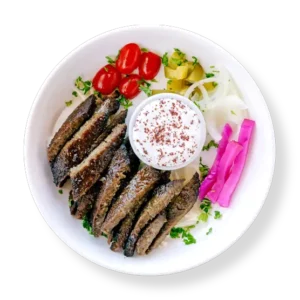 Lamb Gyro -cooked lamb gyro strips roasted on a vertical rotisserie, plated (no wrap) with rice and salad at Aladdin Mediterranean cuisine