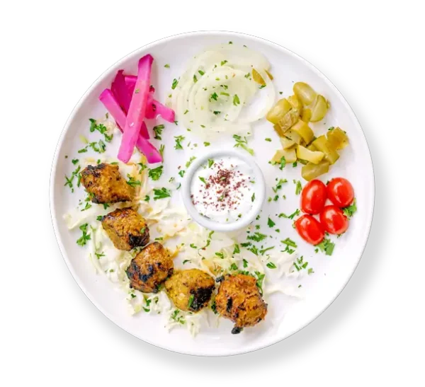 Filet Lamb Kabob with pickles tomatoes and cabbage and garlic sauce Aladdins Houston