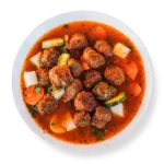 Gluten-free spicy lamb meatballs in smoky chipotle gravy, plated at Aladdins Houston