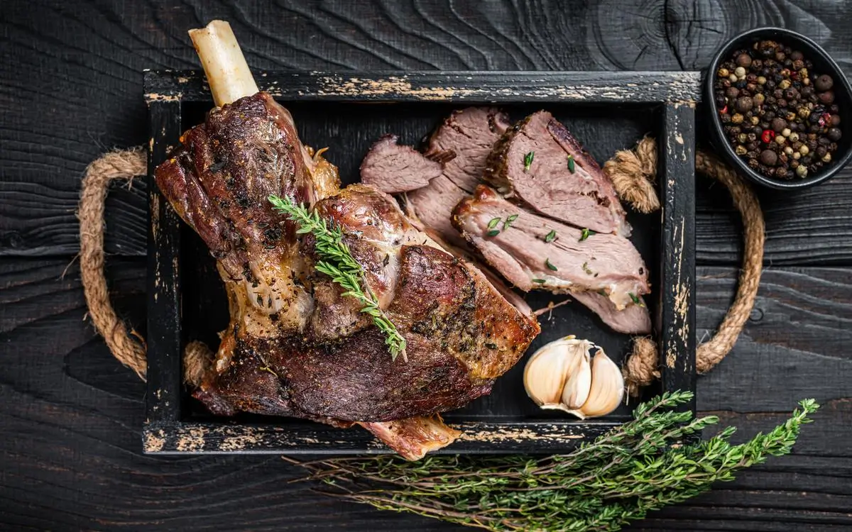 Slow-Roasted Whole Lamb the secrets of the slow-roasted whole lamb recipe for the perfect holiday feast. Aladdin Mediterranean cuisine-style slow-roasted lamb leg sliced and served with garlic and herbs.
