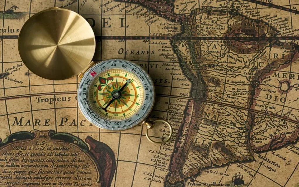 Vintage map with a brass compass, representing the historical origins of Mediterranean dolmas.