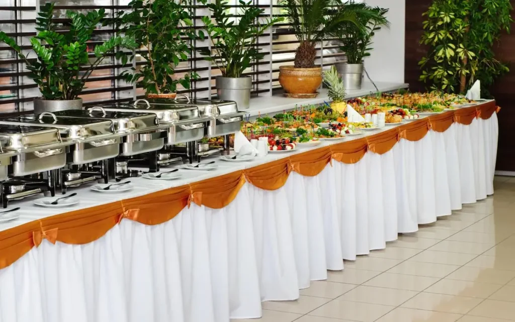 An elegant buffet table lined with various Mediterranean dishes, including vibrant salads, dips, and hot entrées, ready for guests.