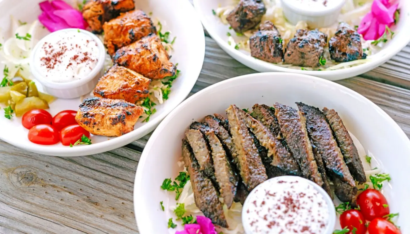 Fresh Mediterranean catering near me in Houston — trays of kabobs, hummus, salads, and pita from Aladdin Mediterranean Cuisine.