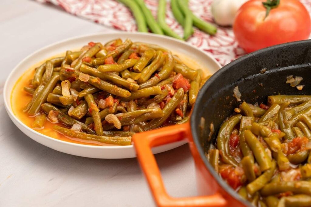 Turkish Green Beans Recipe (Zeytinyağlı) braised with tomatoes and olive oil, served with lemon and herbs